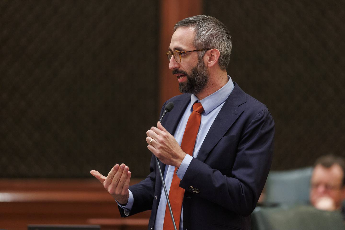 State Rep. Will Guzzardi speaks with members of the House before the chamber passed changes to the controversial criminal justice law known as the SAFE-T Act.