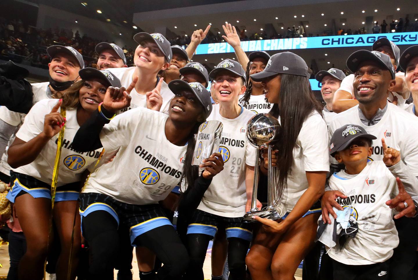 Chicago Sky players, including Kahleah Copper, second from left, celebrate after winning the WNBA championship, 80-74, against the Phoenix Mercury on Oct. 17, 2021, at Wintrust Arena.