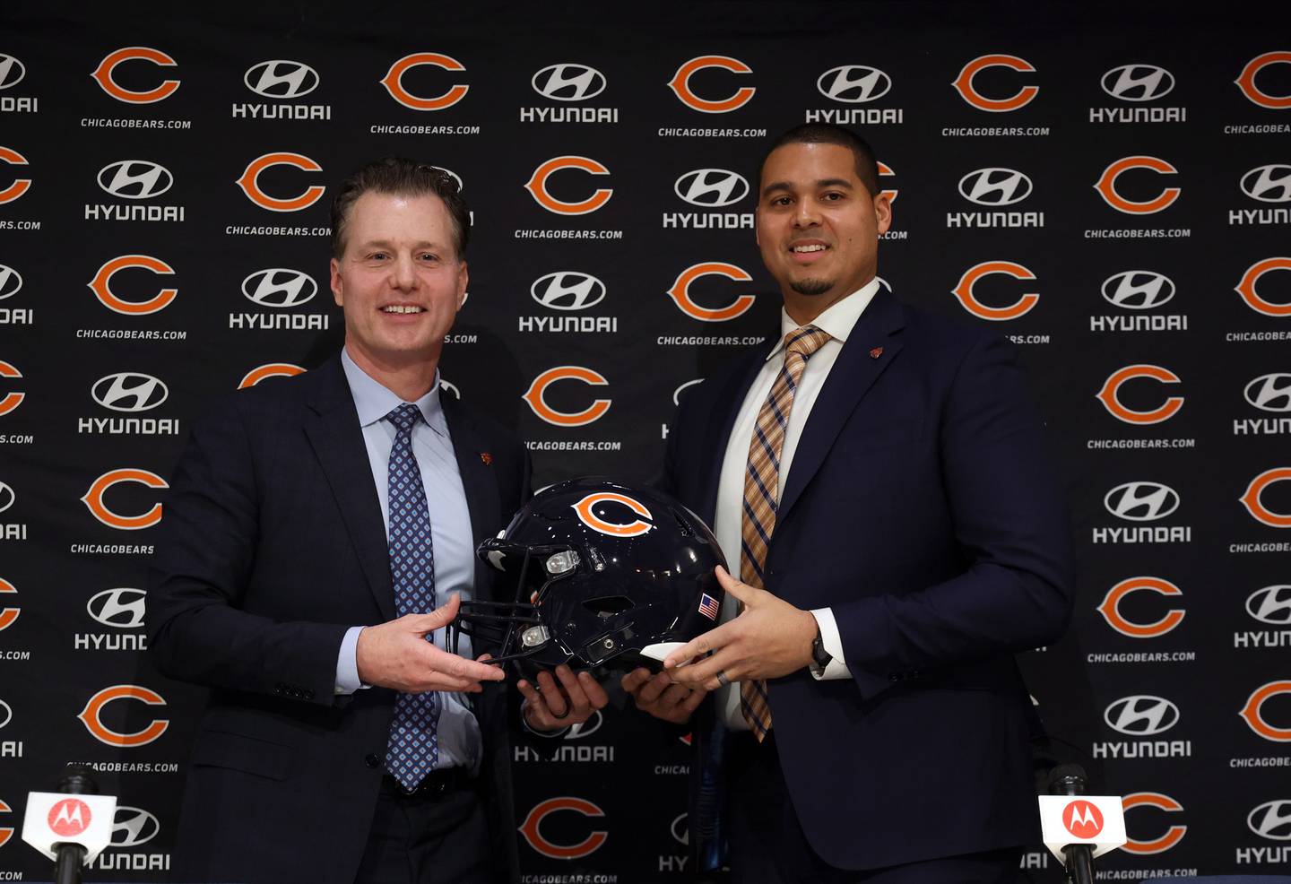 New Bears coach Matt Eberflus and general manager Ryan Poles pose with a helmet after being introduced on Jan. 31, 2022, at Halas Hall.