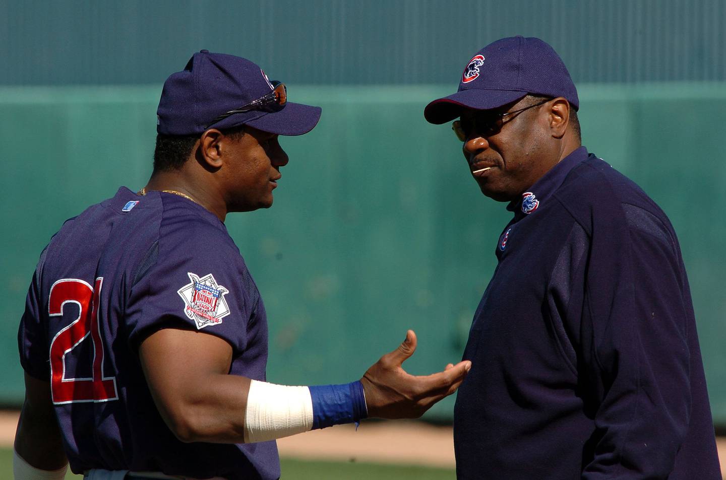 Sammy Sosa and Cubs manager Dusty Baker have a chat at spring training on Feb. 29, 2004.
