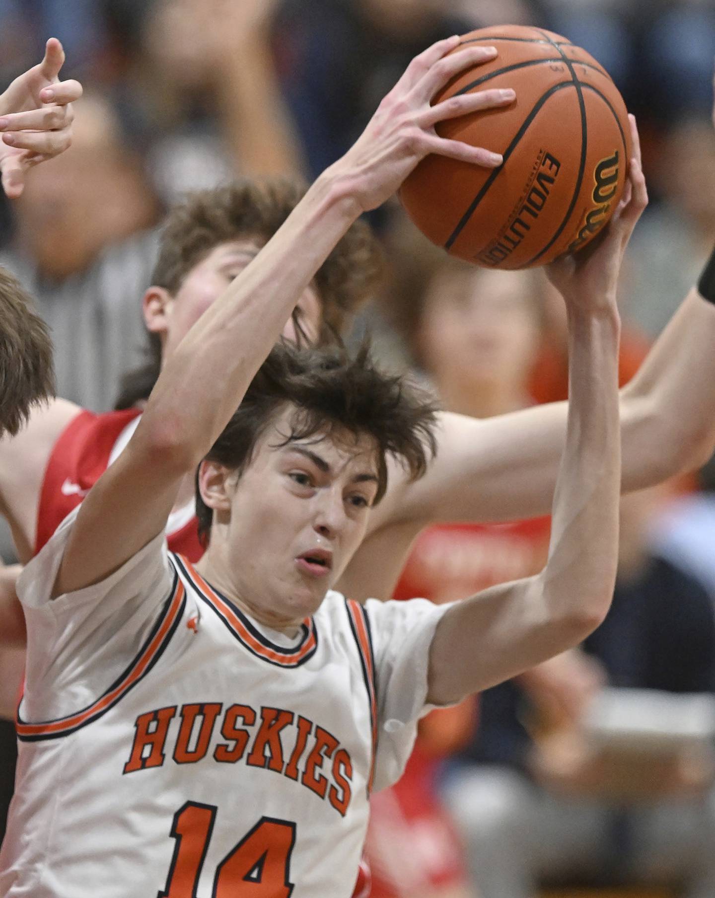 Naperville North’s Jacob Nolen (14) pulls down a rebound during a DuPage Valley Conference game against Naperville Central on Friday, Dec. 16, 2022. 