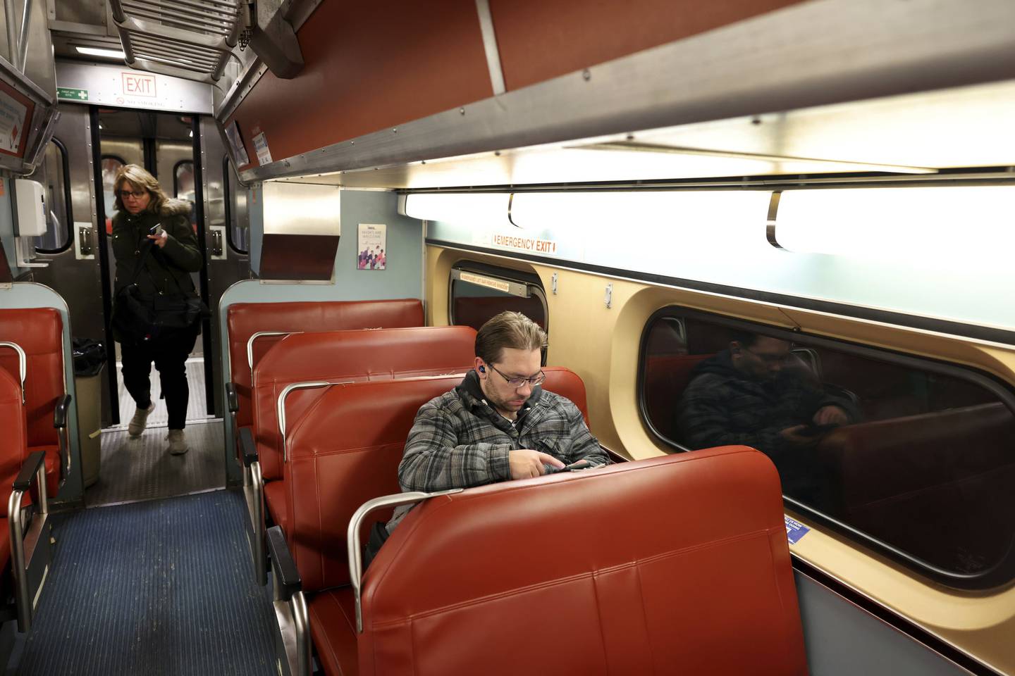 Commuter Mike Gorski relaxes in his seat aboard a Metra Heritage Corridor line train en route to his Willow Springs stop on Dec. 7, 2022.  Gorski takes Metra two days a week for work. 