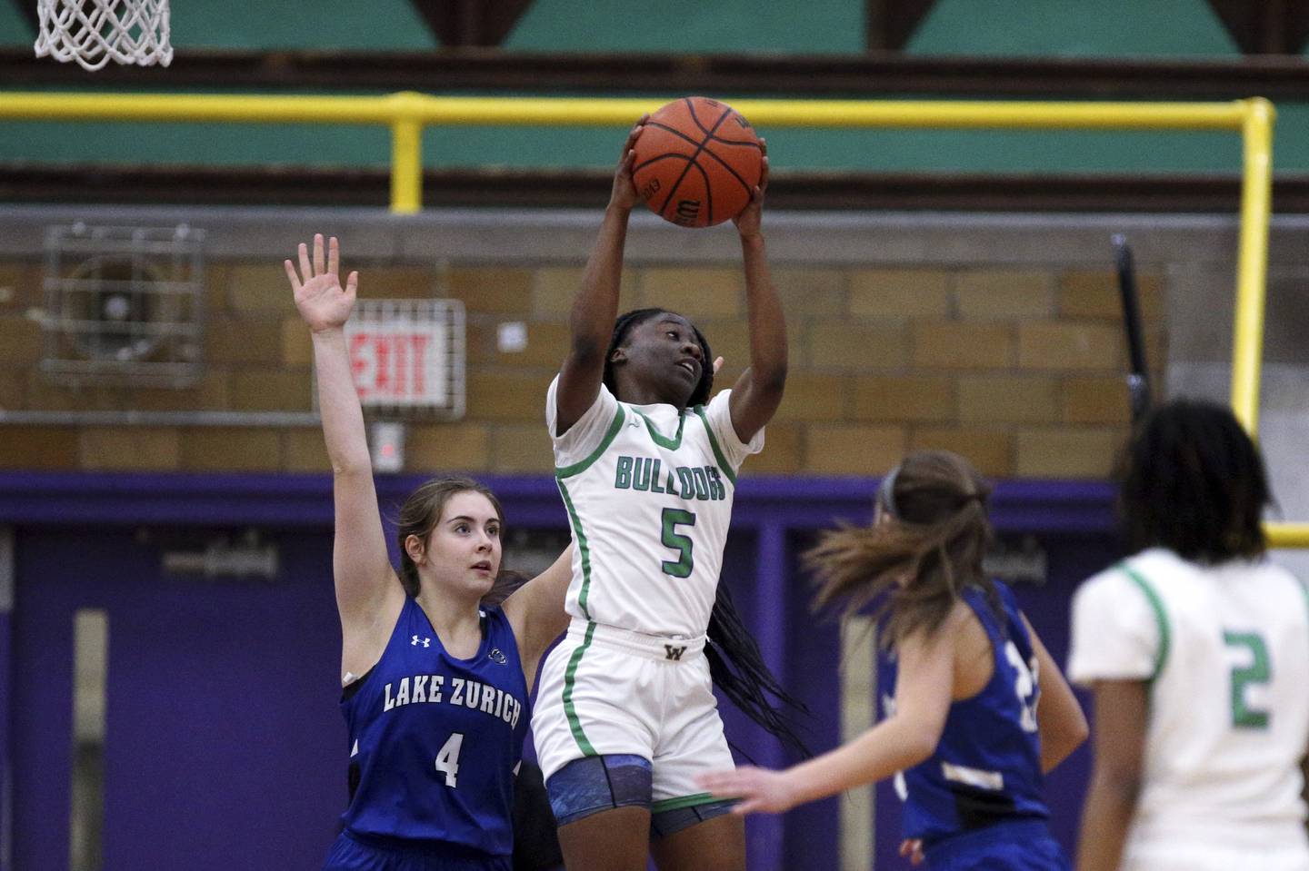 Waukegan’s Andreya’nna Hicks (5) grabs a rebound in front of Lake Zurich’s Molly Friesen (4) during a game in Waukegan on Thursday, Dec. 1, 2022. 