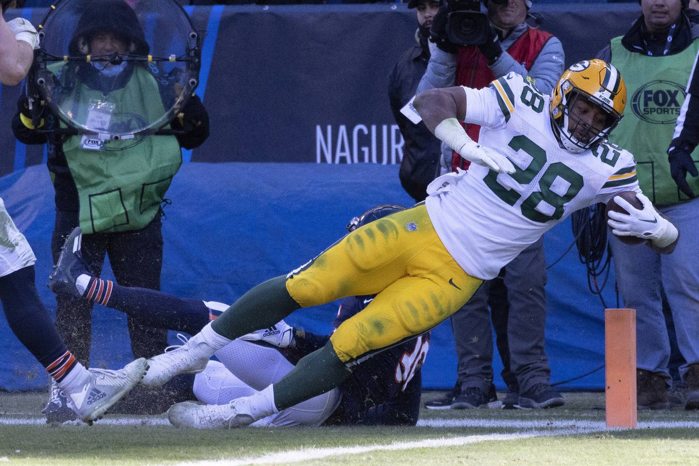 Packers running back AJ Dillon (28) scores a touchdown past Bears safety DeAndre Houston-Carson during the fourth quarter Dec. 4 at Soldier Field. The Bears lost 28-19. 