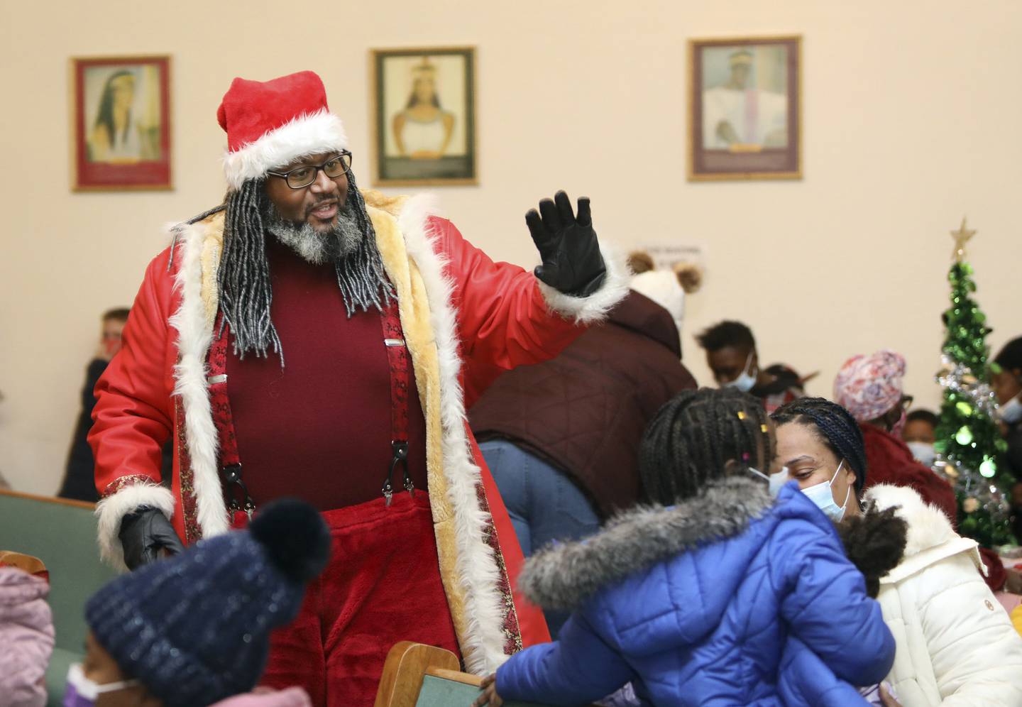 Dreezy Claus, portrayed by Andre Russell, visits families at Rose of Light Church in Chicago on Dec. 17, 2022.  