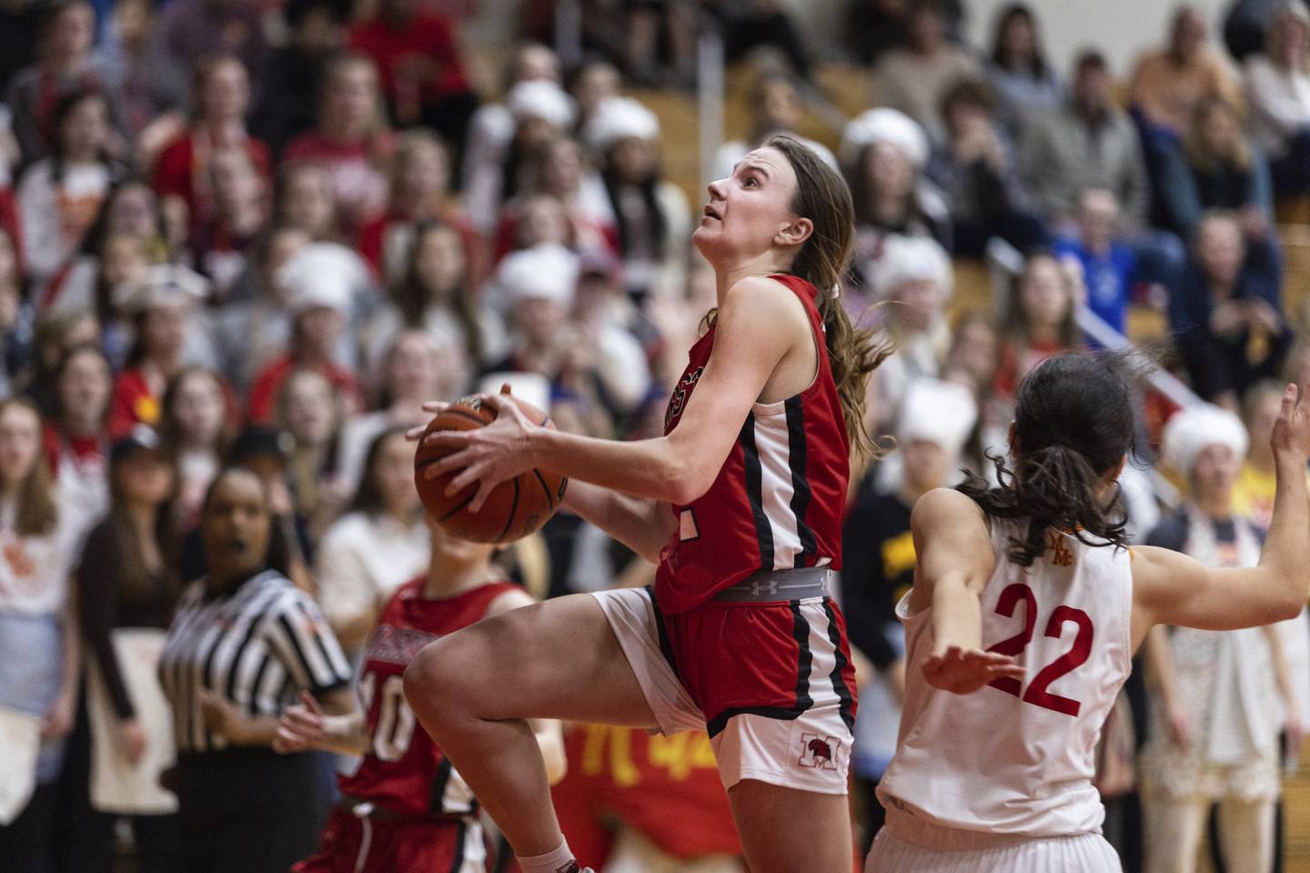 Marist’s Elise Ward (2) goes to the basket as Mother McAuley's Maeve Egan (22) defends during a nonconference game on Thursday, Dec. 8, 2022.