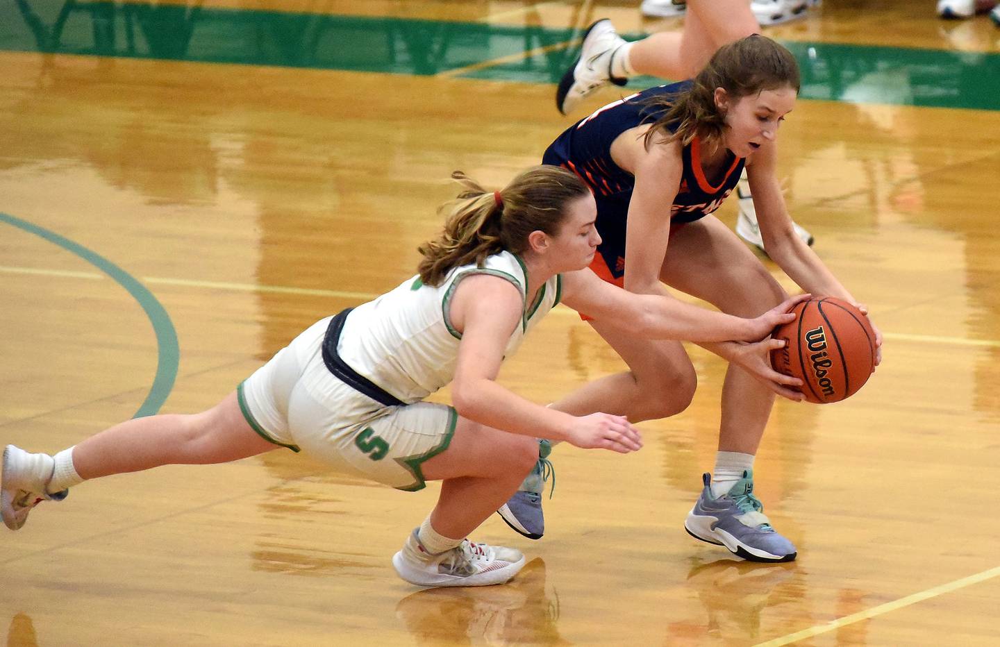 Stagg's Abbey Hobart (14) and Oak Lawn's Rose Savaglio (10) chase down a loose ball during a nonconference game in Oak Lawn on Tuesday, Dec. 20, 2022.