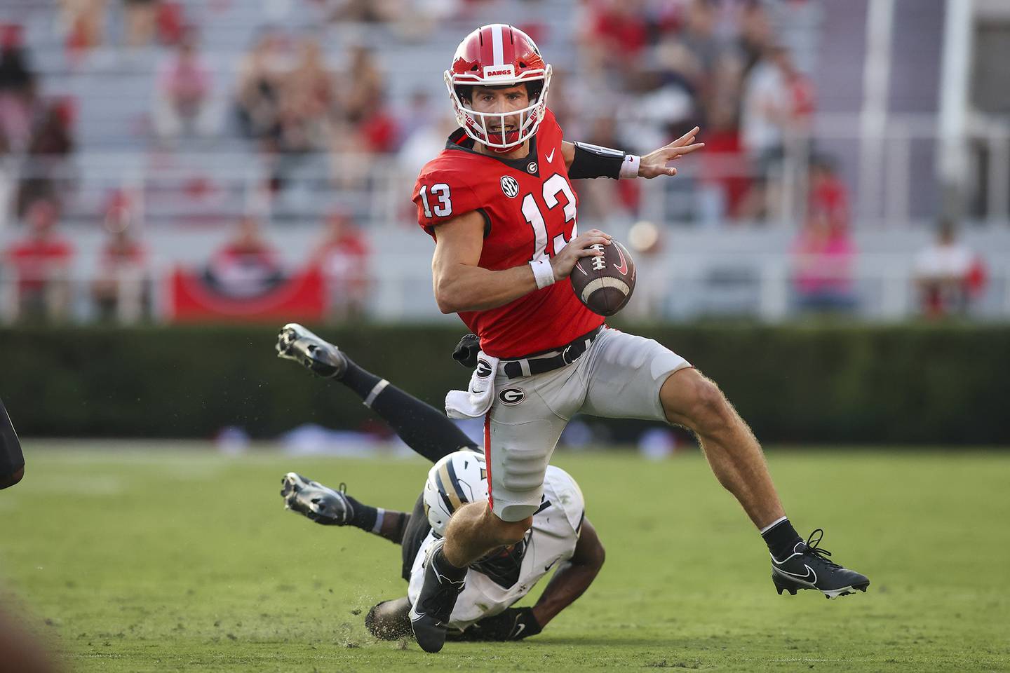 Georgia quarterback Stetson Bennett scrambles away from Vanderbilt linebacker CJ Taylor during an Oct. 15 game. The Bulldogs will face Ohio State in the Peach Bowl on Saturday in a College Football Playoff semifinal.