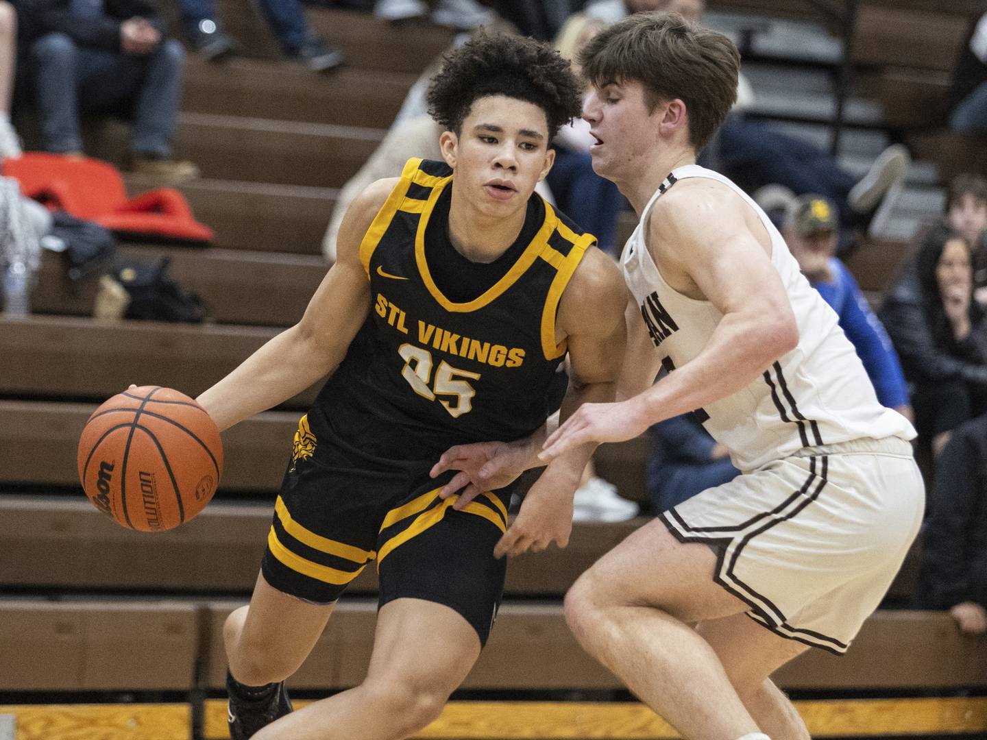 St. Laurence's Jacob Rice (25) tries to drive past Mount Carmel's Richard Zoller during a game in Chicago on Tuesday, Dec. 6, 2022.