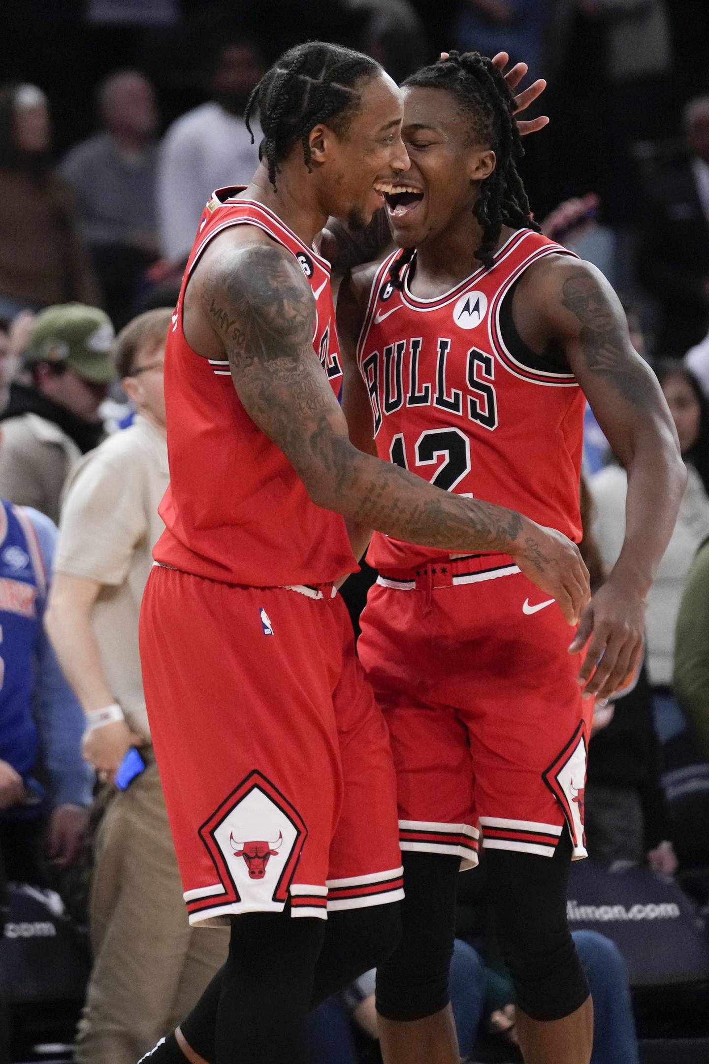 Chicago Bulls' DeMar DeRozan, left, and Ayo Dosunmu celebrate after an NBA basketball game against the New York Knicks, Friday, Dec. 23, 2022, in New York. The Bulls defeated the Knicks 118-117. (AP Photo/Seth Wenig)