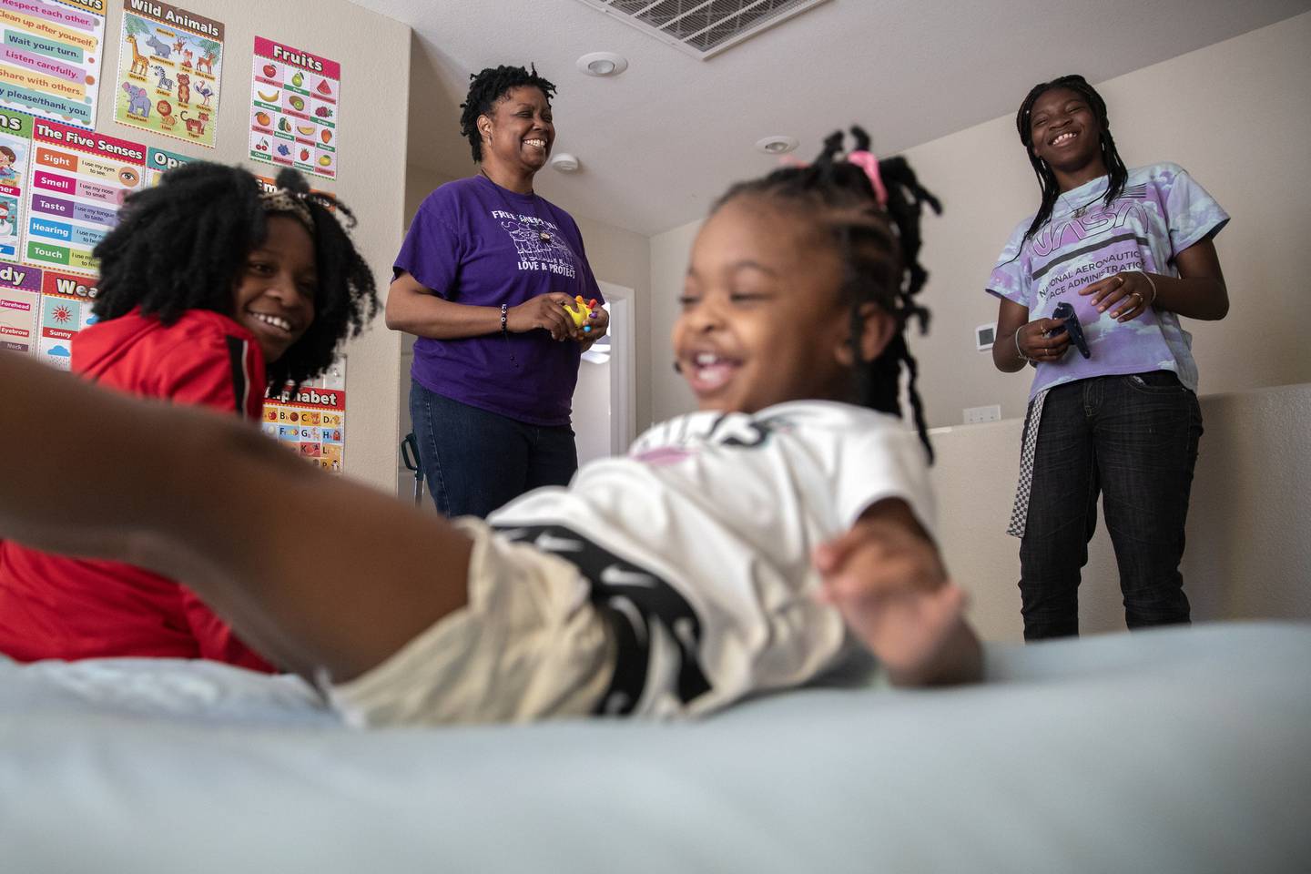 Sandra Brown visits with her grandchildren Sapphire, 11, from left, Azariah, 2, and Kaniyah, 12, on April 27, 2022, at their home in Las Vegas. 
