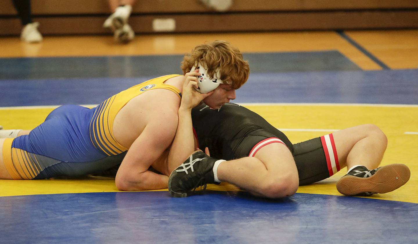 Lyons’ Cooper King, left, pins Lincoln-Way Central’s Dominick Danno in a 195-pound match during the Lyons mega duals in La Grange on Saturday, Dec. 10, 2022.