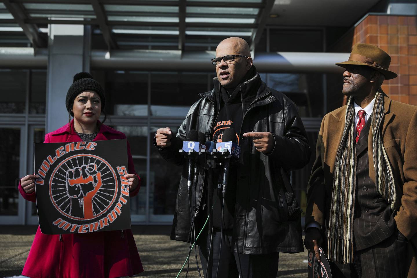 Tio Hardiman, center, executive director for Violence Interrupters, announces strategy for restoring safety on trains at a news conference outside of Chicago police headquarters on March 11, 2022.  