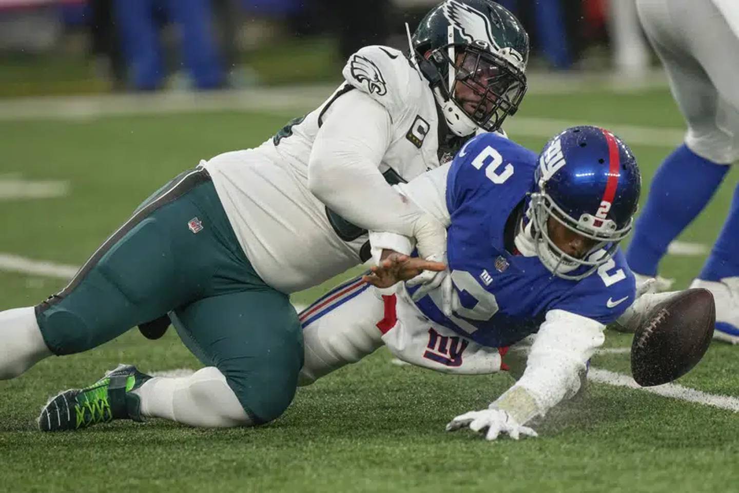 Eagles defensive end Brandon Graham, left, forces a fumble by Giants quarterback Tyrod Taylor during the fourth quarter Sunday in East Rutherford, N.J.