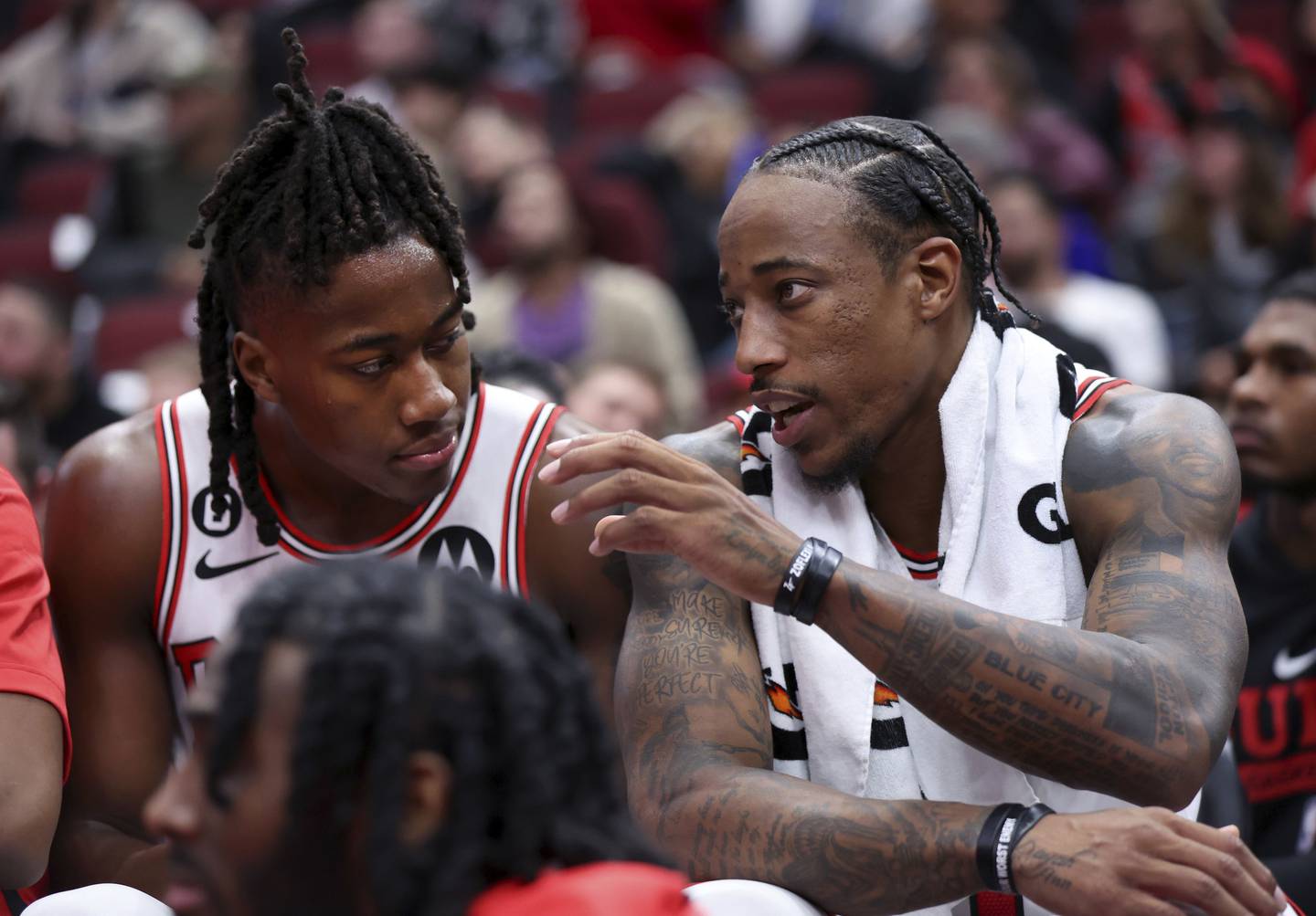 DeMar DeRozan (right) talks with Bulls teammate Ayo Dosunmu in the second half of a preseason game against the Pelicans at the United Center on Oct. 4, 2022. 