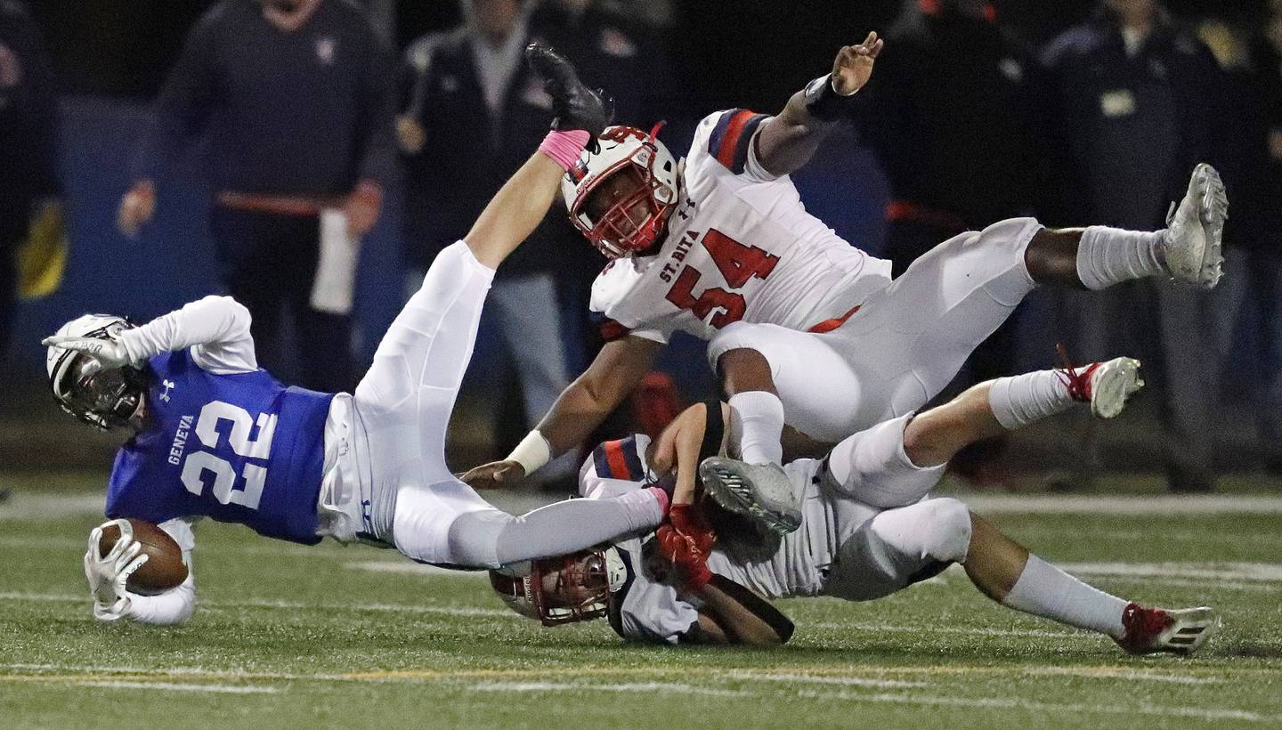 St. Rita's Johnny Schmitt (7) tackles Geneva's Nate Stempowski during a Class 7A second-round playoff game in Geneva on Friday, Nov. 5, 2021.