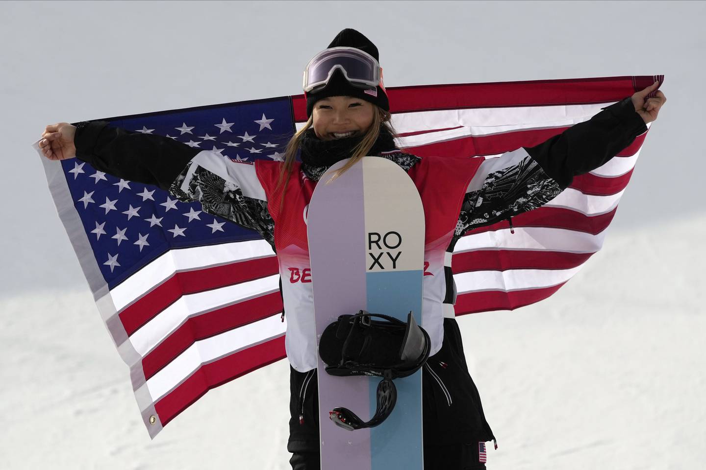Chloe Kim celebrates during the venue ceremony for the women's halfpipe at the 2022 Winter Olympics on Feb. 10, 2022.