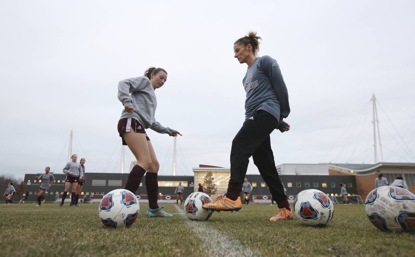 Julianne Sitch, right, dribbles the ball while working with the University of Chicago women's soccer team during practice in Chicago on Tuesday Nov. 28, 2017.
