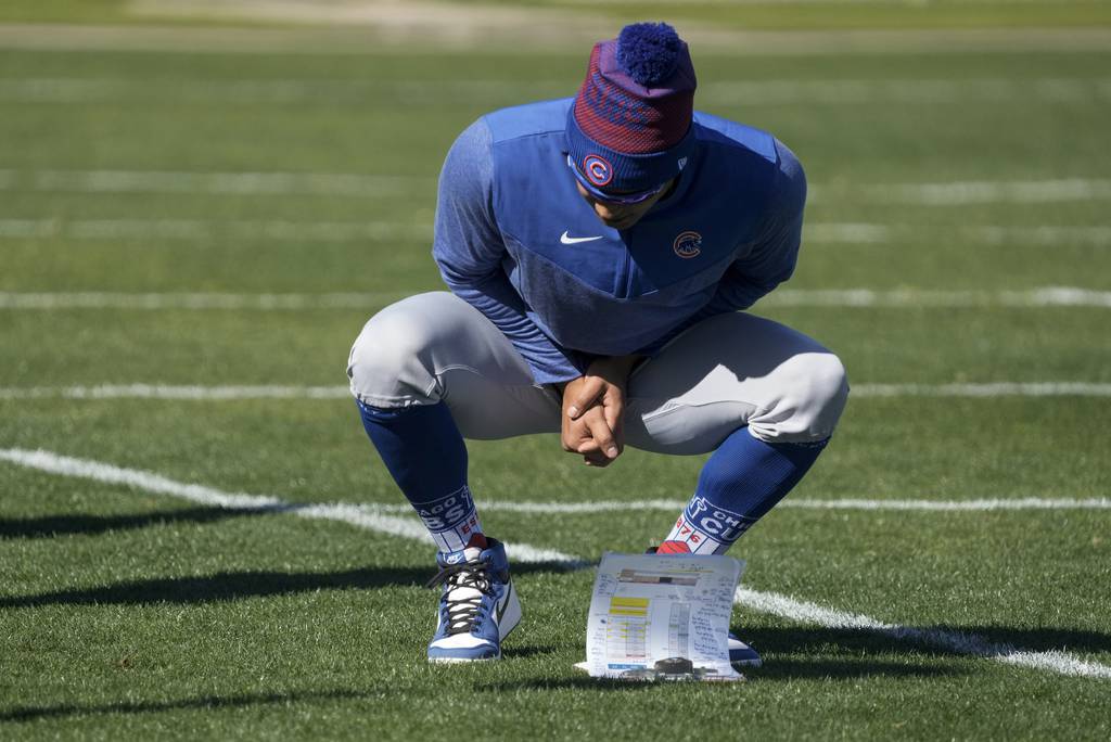 Adbert Alzolay looks at a clipboard during a Cubs spring training workout on Feb. 15, 2023.