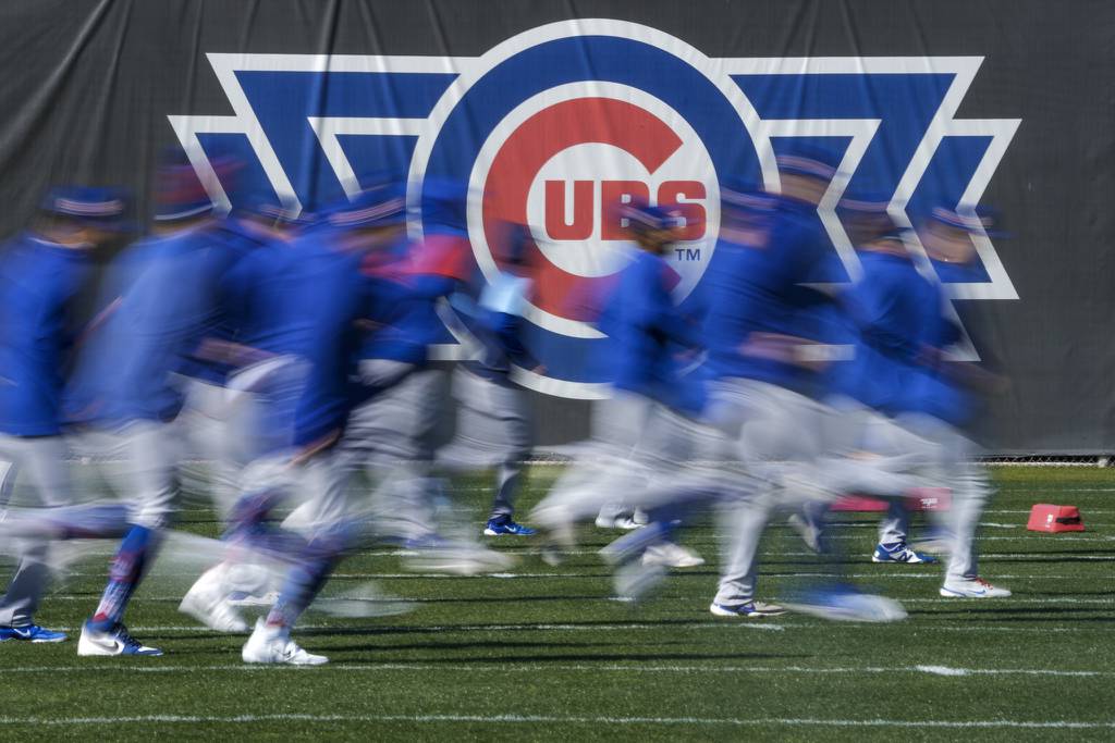 Some Cubs players run during a spring training workout on Feb. 15, 2023.