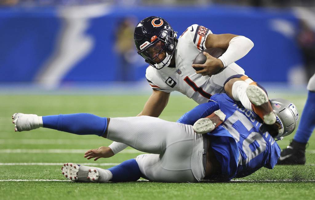 Bears quarterback Justin Fields is sacked by Lions linebacker James Houston on Jan. 1, 2023, in Detroit.