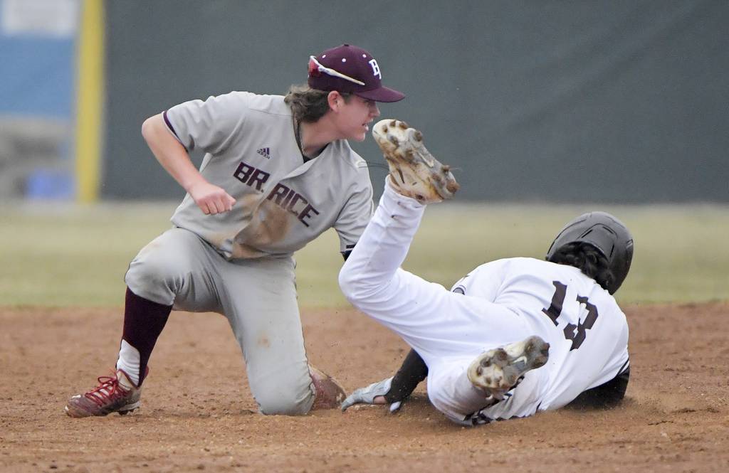 Brother Rice's Gavin Triezenberg (16) puts the tag on Joliet Catholic's Brett Hulbert (13) at second base during a nonconference game in Joliet on Wednesday, March 22, 2023.