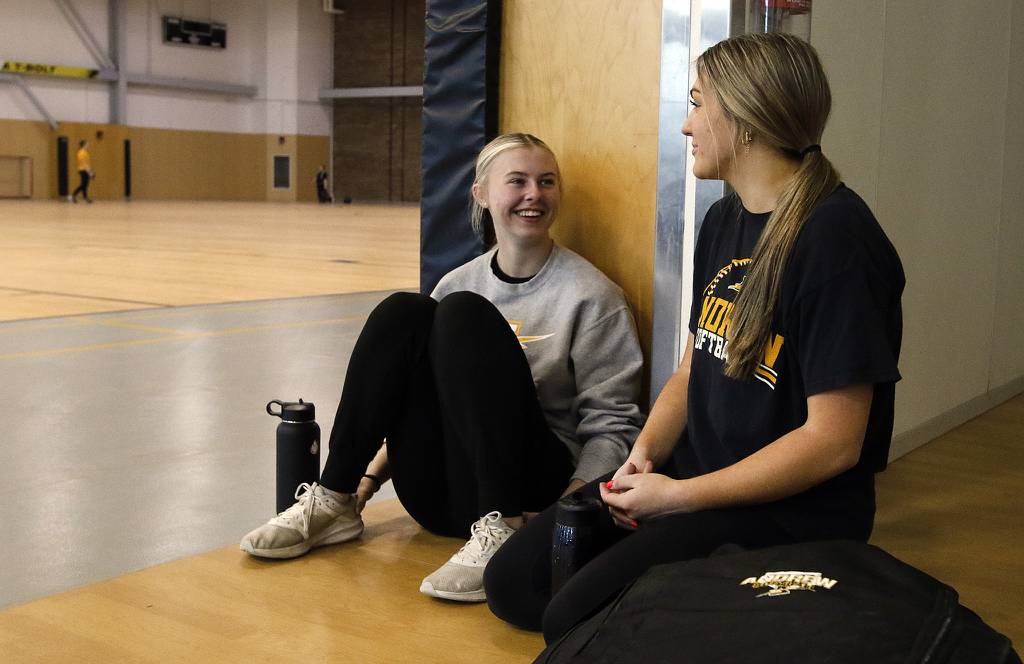 Andrew's Madison Vrastil, left, and Teagan Gutsch take a break after indoor practice in Tinley Park on Wednesday, March 29, 2023.