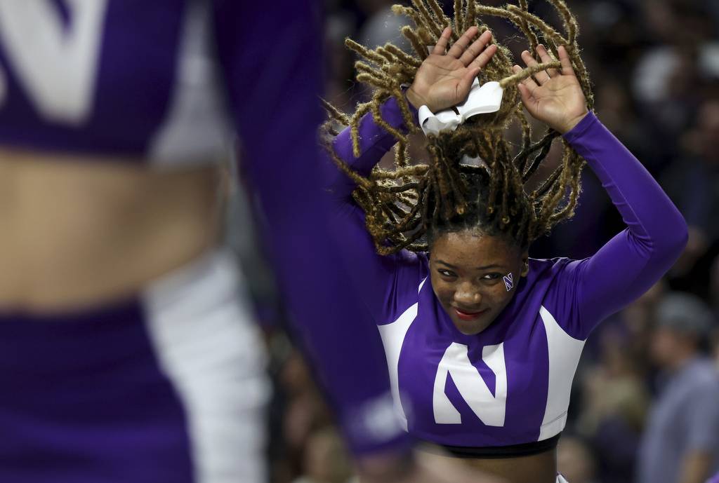 A Northwestern cheerleader celebrates on the sideline in the second half on March 1, 2023, at Welsh-Ryan Arena in Evanston.