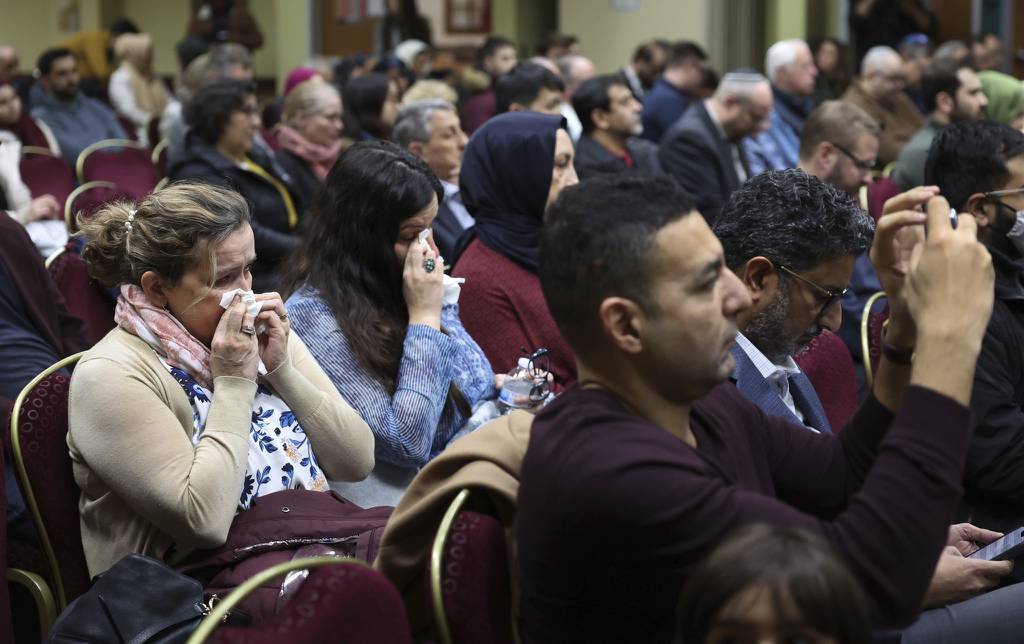 Gulce Gavaz, left, of New York, and her daughter, Mevla Gavaz, of Norwood Park, wipe away tears while attending a vigil to pray and take action for the victims of the earthquake in Turkey and Syria.  The vigil took place at the Turkish American Society of Chicago in Mount Prospect.