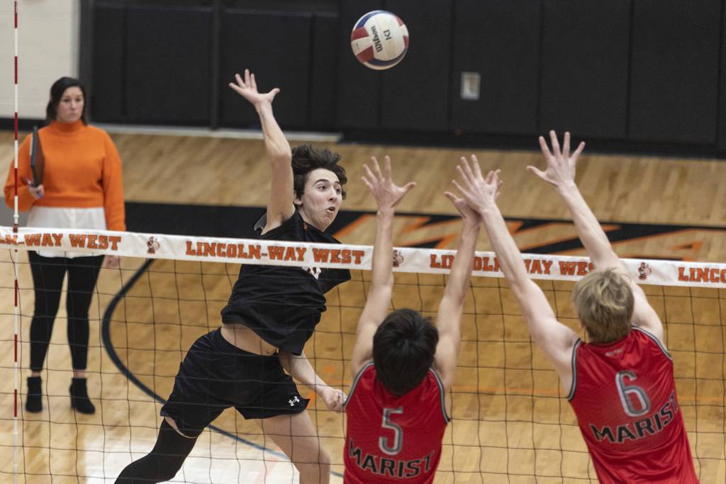 Lincoln-Way West's Benen Flores (18) tries to cut a kill past the block against Marist during a nonconference match in New Lenox on Thursday, March 30, 2023.