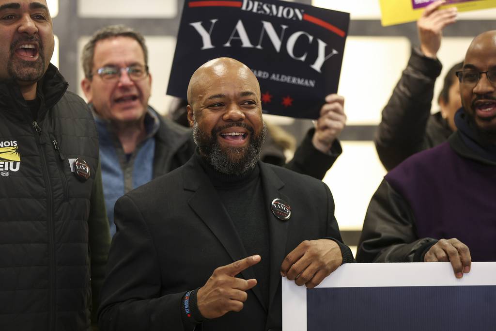 5th Ward alderman candidate Desmon Yancy with community members at a canvassing event on March 18, 2023, in the South Shore neighborhood. 