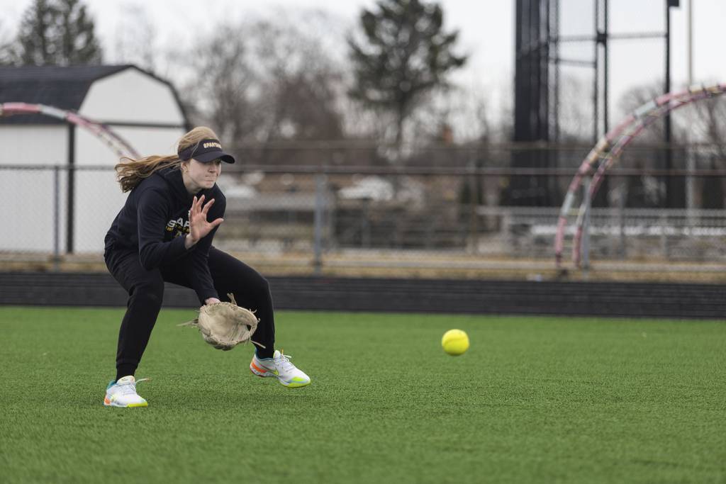 Marian Catholic's Gracie Jensen fields a ground ball during practice in Chicago Heights on Monday, March 20, 2023.