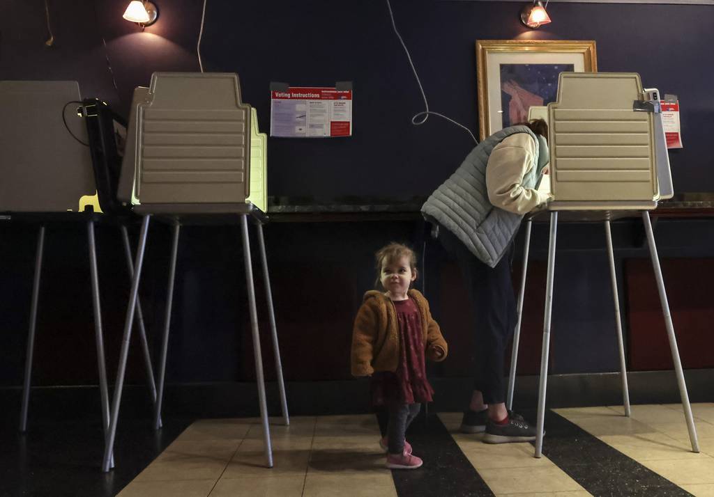 Ainsley and Katherine Fraser vote at the polling location inside Silvie’s Bar on Feb. 28, 2023, in North Center. 