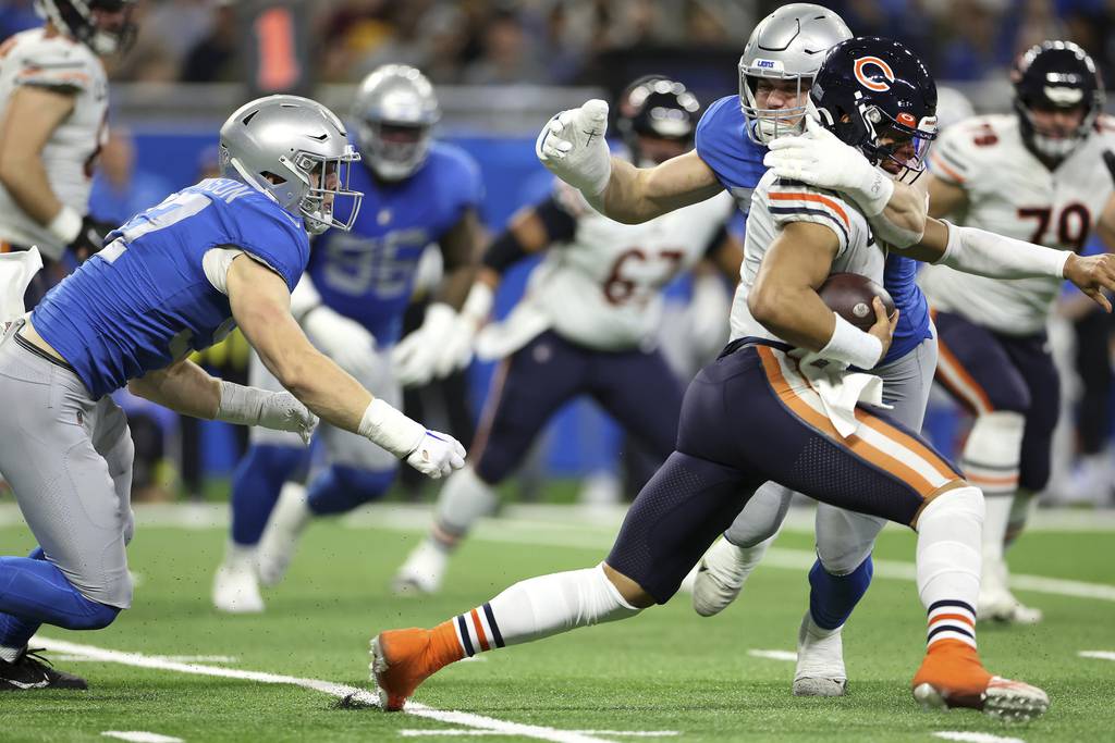 Bears quarterback Justin Fields is taken down by Lions defensive end John Cominsky on Jan. 1, 2023, in Detroit.