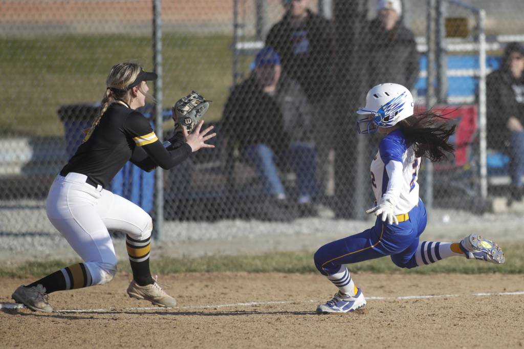 Sandburg’s Jenna Kucik, right, slides safely into third base against St. Laurence’s Jordan Ogean during a nonconference game in Orland Park on Monday, March 27, 2023.
