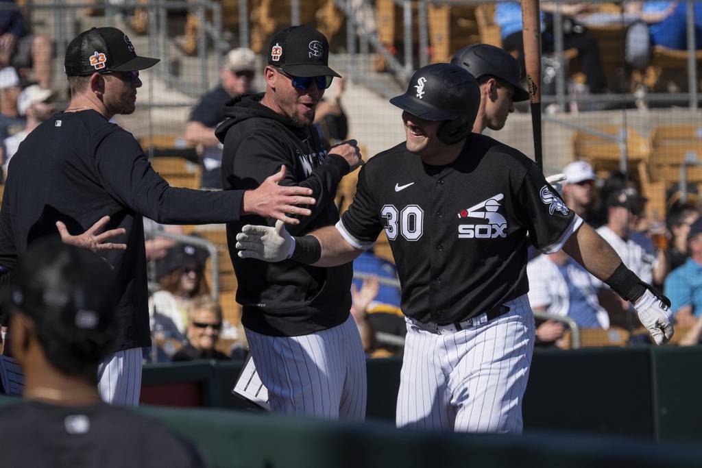 White Sox players celebrate Jake Burger’s two-run homer in the sixth inning of a 10-1 victory over the Mariners on Feb. 27 at Camelback Ranch in Glendale, Ariz. 