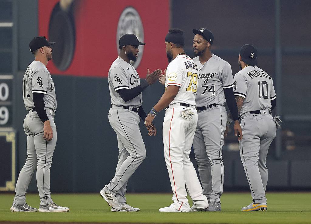 Astros first baseman Jose Abreu greets his former White Sox teammates on opening day Thursday at Minute Maid Park in Houston. 