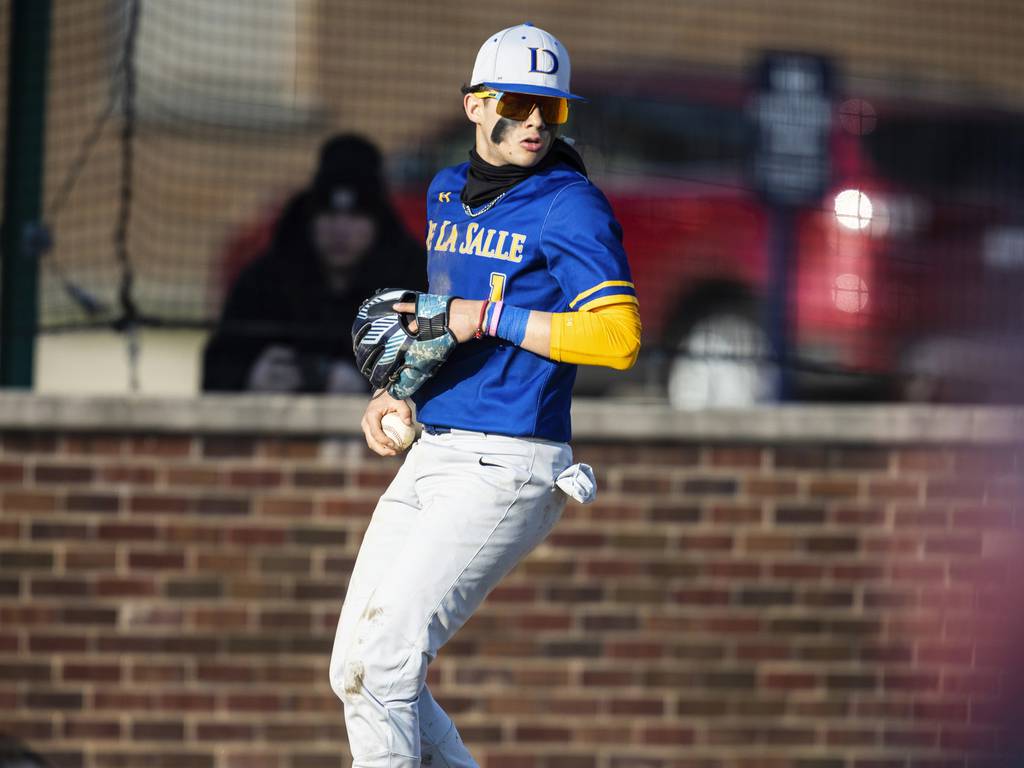 De La Salle’s Kenny Perez (1) looks to make sure a St. Rita runner stays on base during a Catholic League crossover in Chicago on Tuesday, March 28, 2023.