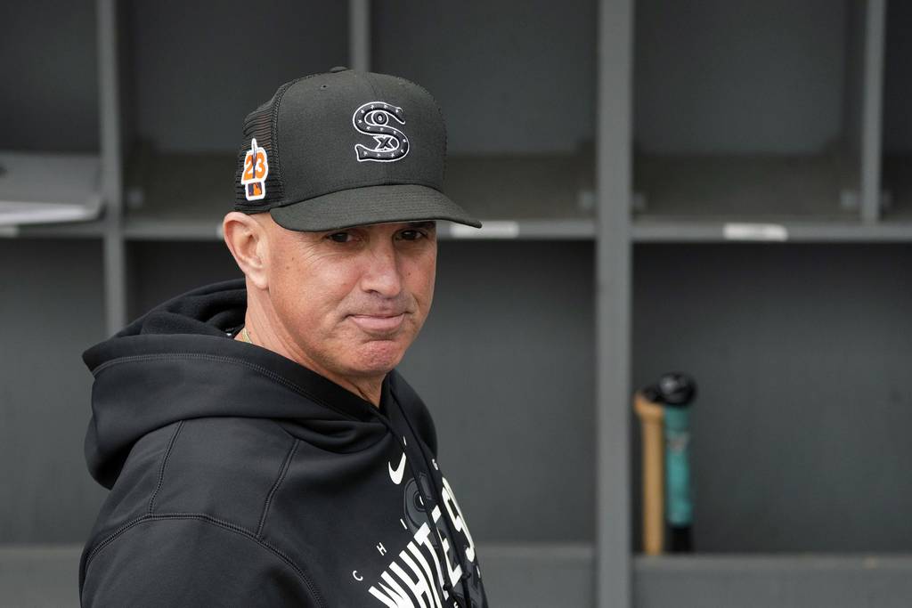 White Sox manager Pedro Grifol pauses in the dugout before a spring training game against the Guardians on March in Glendale, Ariz. 