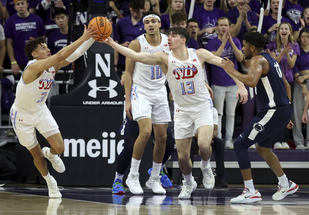 Northwestern guard Ty Berry, left, pulls down a rebound after a blocked shot by guard Brooks Barnhizer (13) in the first half on March 1, 2023, at Welsh-Ryan Arena in Evanston.
