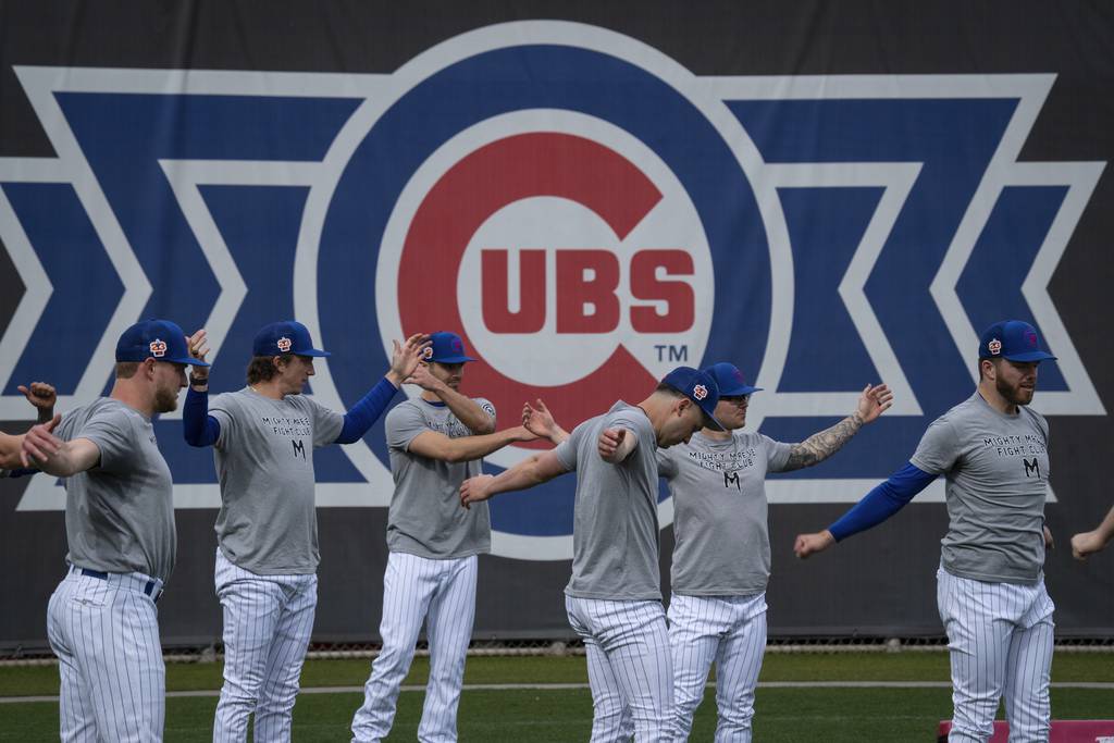 Cubs players warm up before the Cubs’ preseason opener at Sloan Field in Mesa, Arizona on Feb. 25, 2023.  