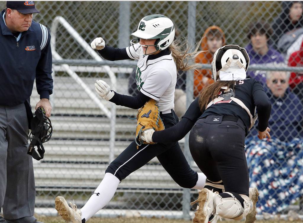 Providence's Lauren Gade, left, gets tagged out at the plate by Lincoln-Way Central's Mia Guide during a nonconference game in New Lenox on Tuesday, March 21, 2023.