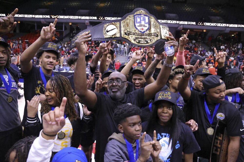 Simeon Career Academy basketball coach Robert Smith holds up a championship belt after his team won the Chicago Public League championship game at Credit Union 1 Arena in Chicago on Feb. 11, 2023. Simeon beat Kenwood Academy 72-64 in overtime. 