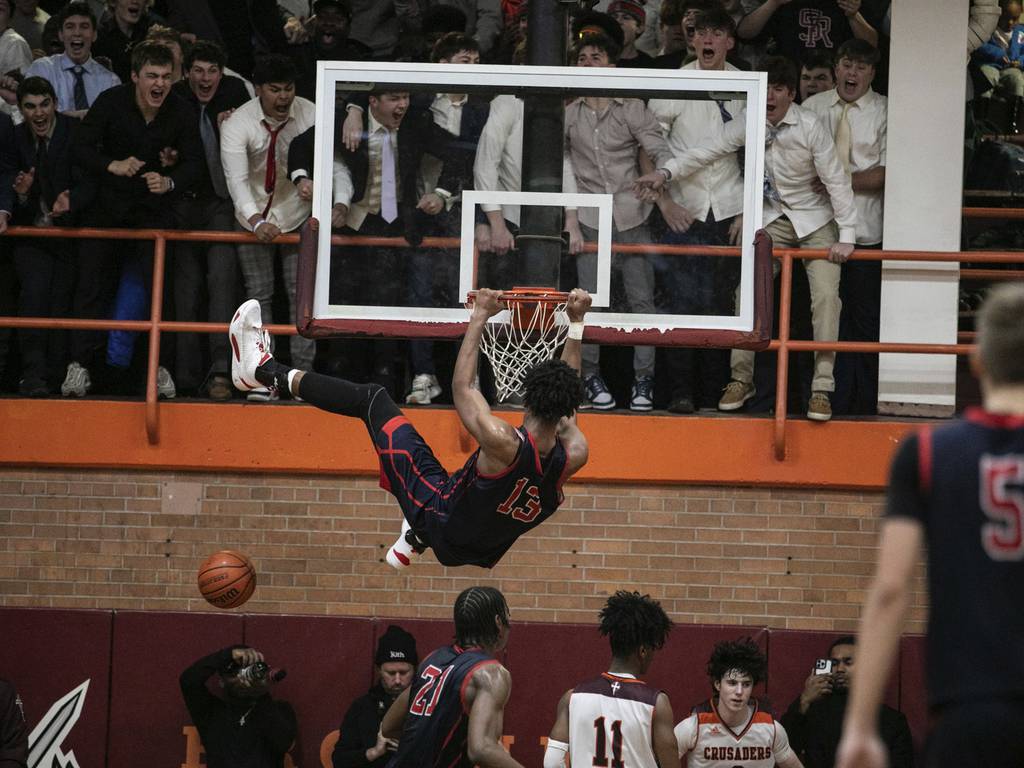 St. Rita's James Brown (13) finishes off an alley-oop dunk against Brother Rice during a Catholic League Blue game in Chicago on Thursday, Dec. 9, 2022.