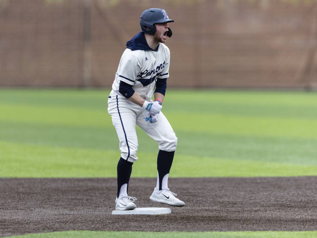 Lemont’s Carter Storti (9) celebrates after stealing second base against Evergreen Park during a South Suburban Conference crossover in Evergreen Park on Tuesday, March 21, 2023.