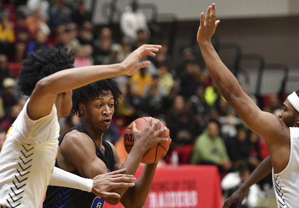 Lincoln-Way East's George Bellevue looks to pass the ball while double teamed by Joliet West during a Class 4A Bolingbrook Sectional semifinal game on Tuesday, Feb. 28, 2023.