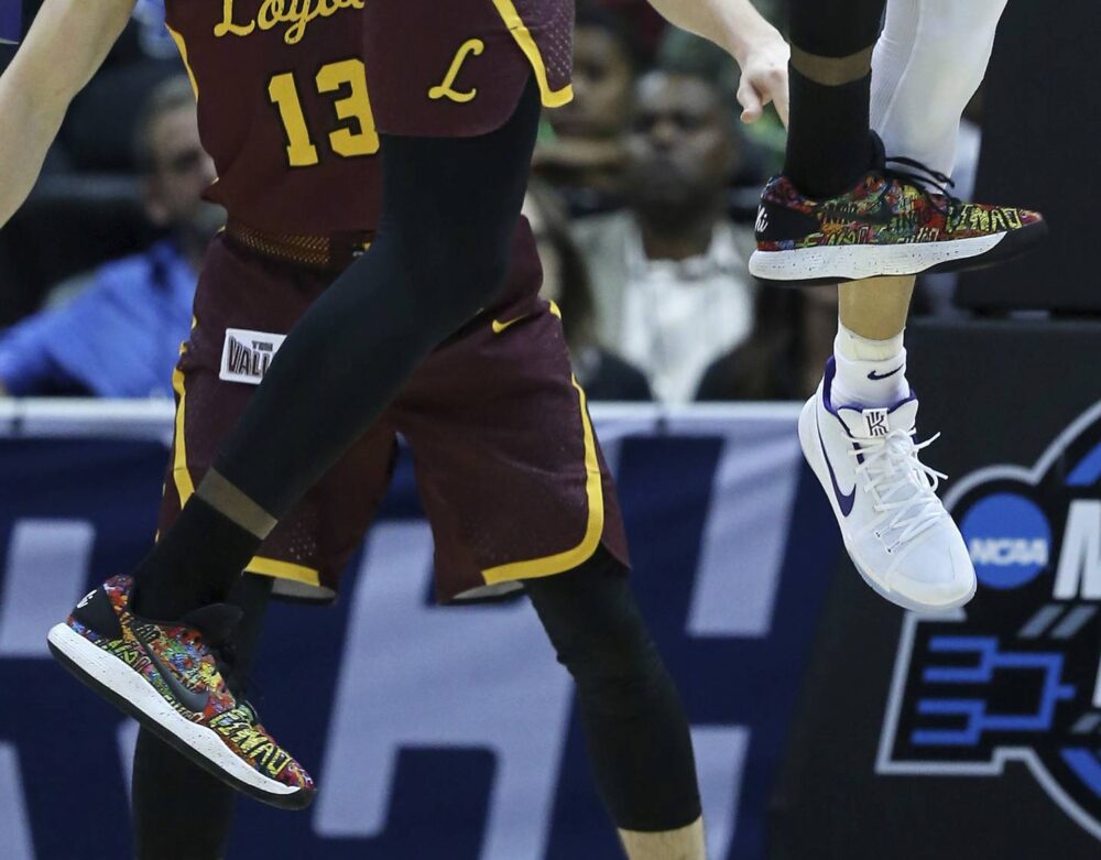 Loyola Ramblers guard Donte Ingram goes up for a rebound in the second half of the Elite 8 game of the NCAA tournament, March 24, 2018, in Atlanta. He's wearing his prized, multicolored Nike shoes with "FINAO" written in graffiti type. Nike created the shoes in honor of Saieed Ivey. 