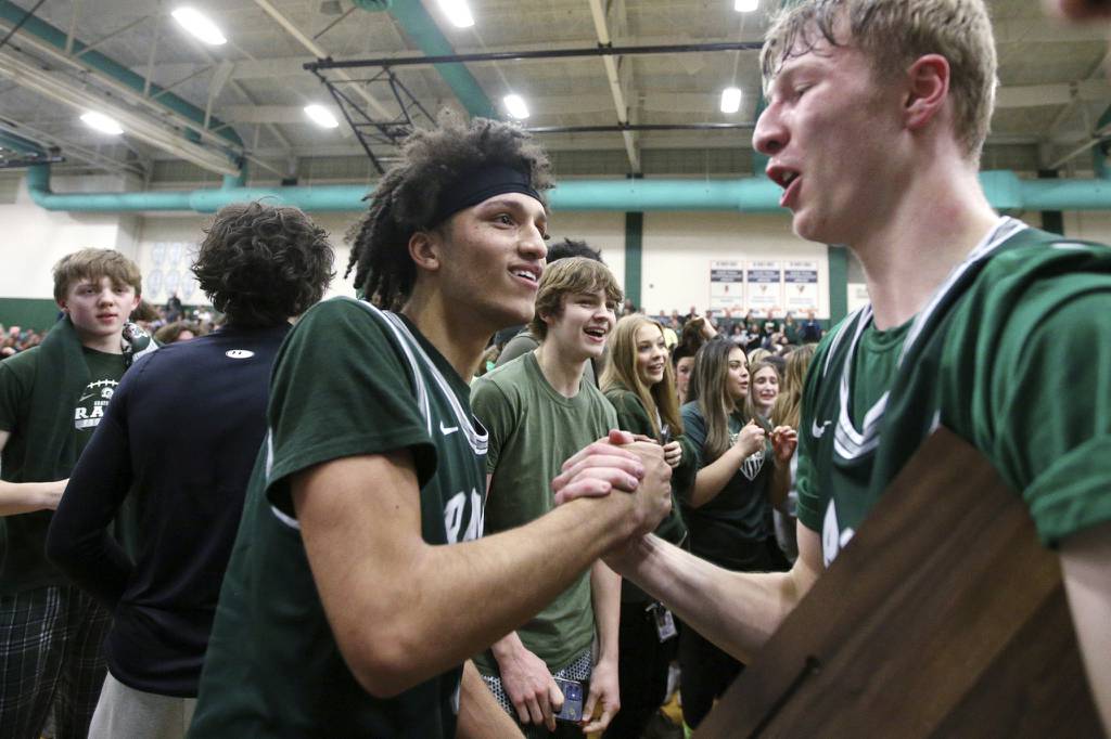 Grayslake Central’s Kai Taylor, left, celebrates with teammate Dennis Estepp after winning the Class 3A Grayslake Central Sectional championship game against Lake Forest on Friday, March 3, 2023.  (Mark Ukena / News-Sun)