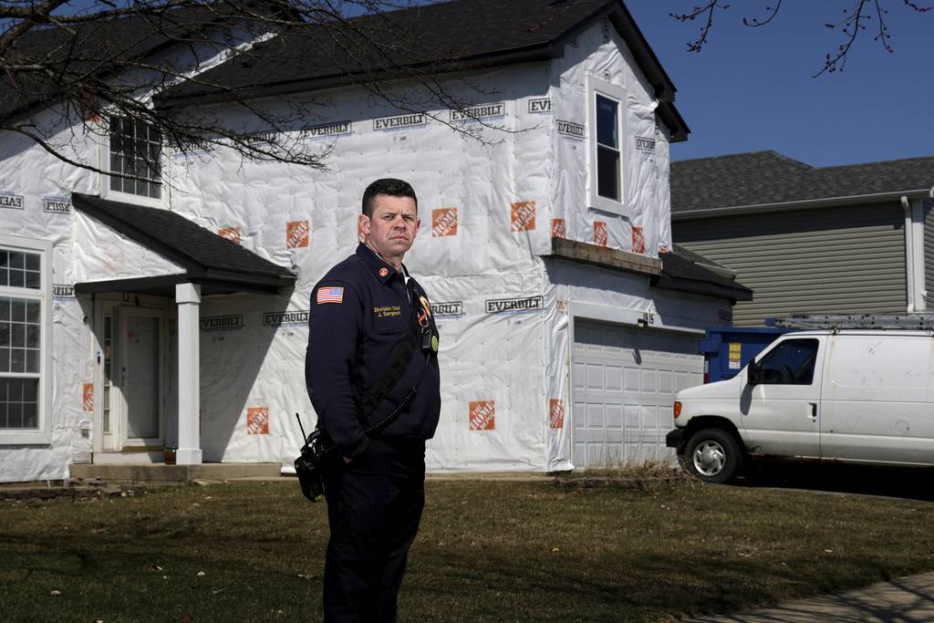 Naperville division chief John Sergeant stands near a home along Spice Circle that is still being repaired from the 2021 tornado on March 27, 2023, in Naperville.   