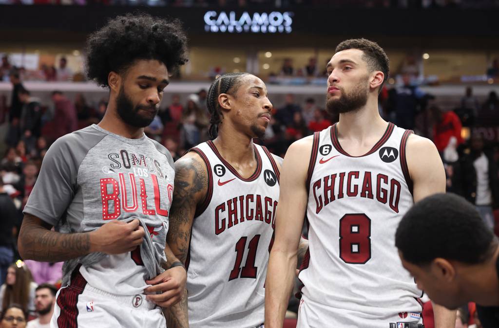 Bulls guard Coby White, from left, forward DeMar DeRozan and guard Zach LaVine leave the bench after a 125-104 loss to the Suns on Friday at the United Center. 